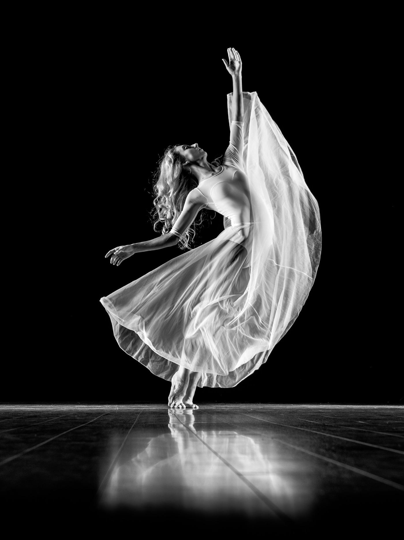 Dancer moving dynamically in a studio